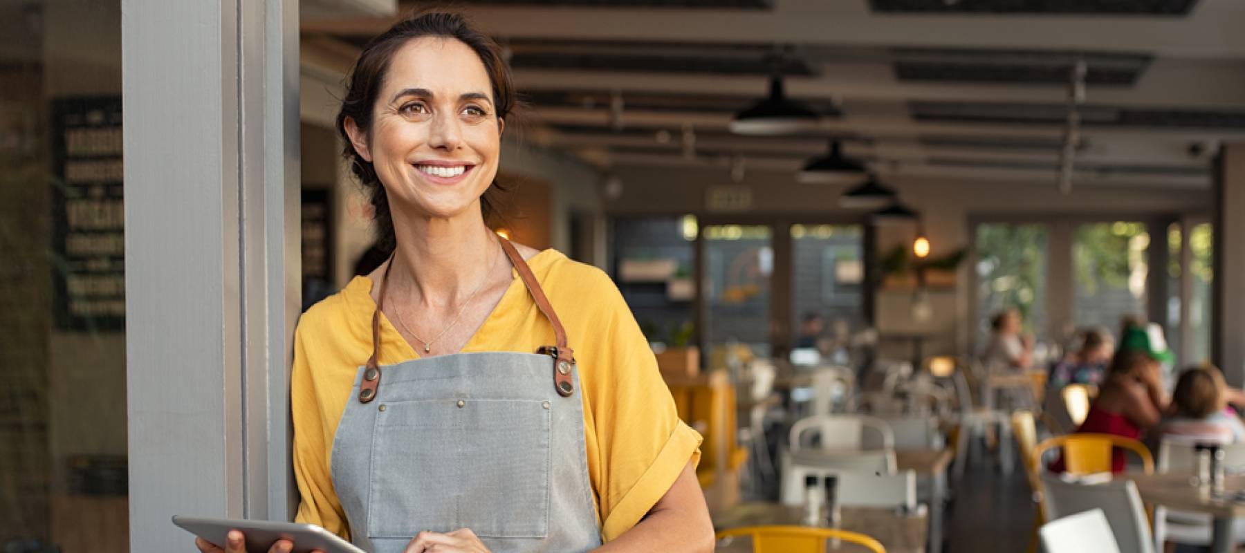 Waitress standing outside restaurant