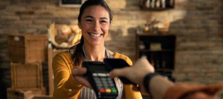 Woman holding payment machine
