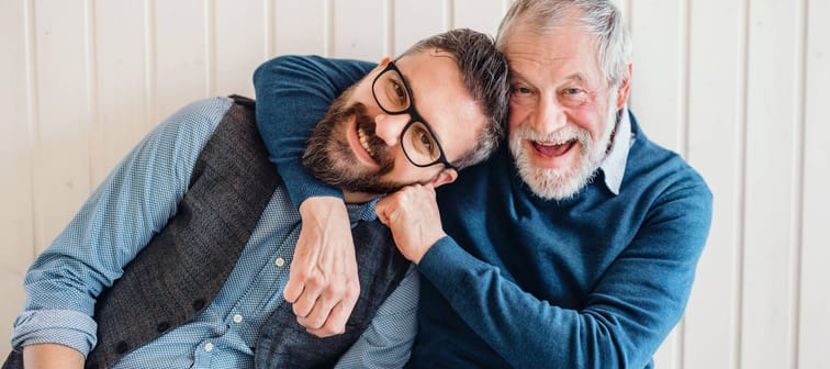 A portrait of adult hipster son and senior father