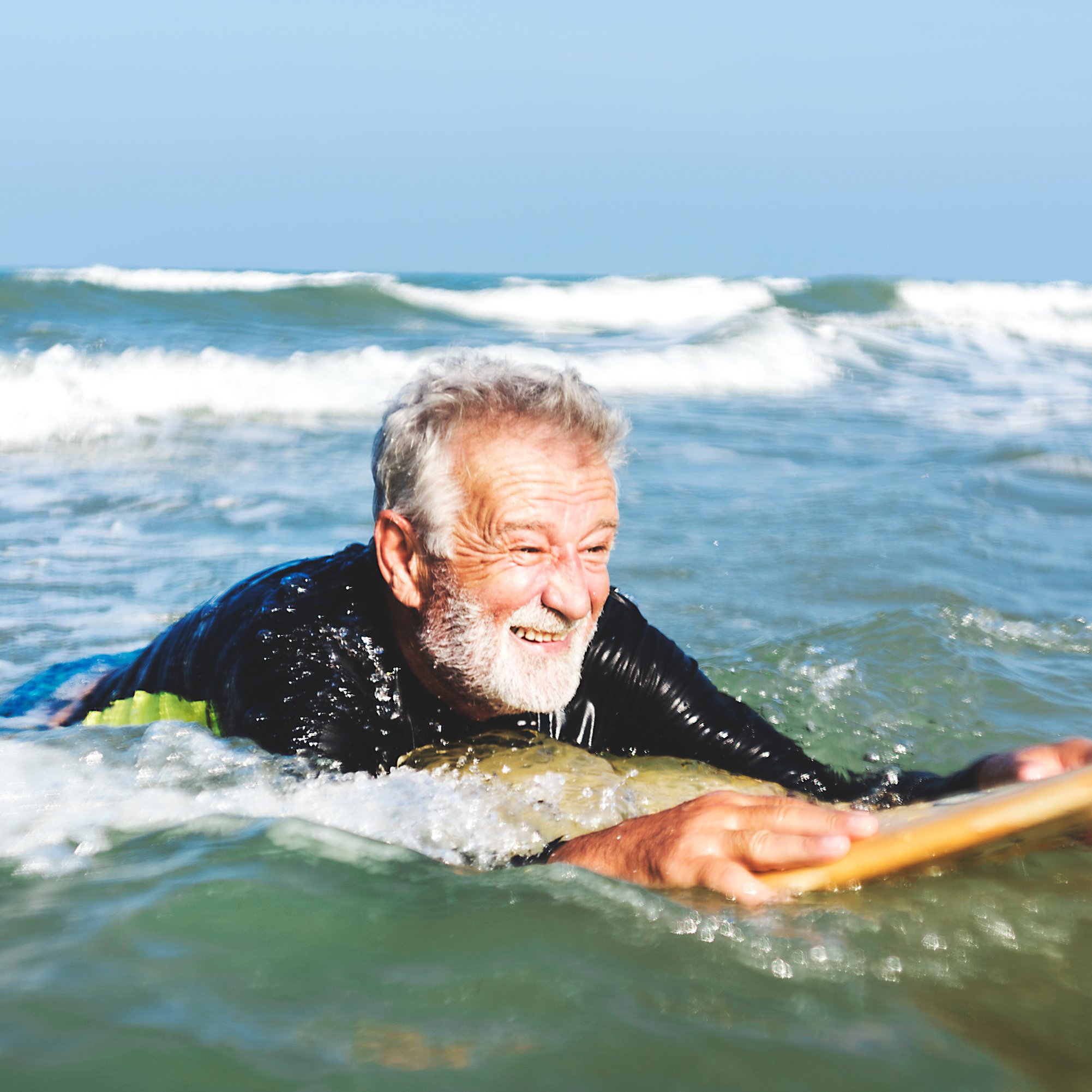 Senior man surfing